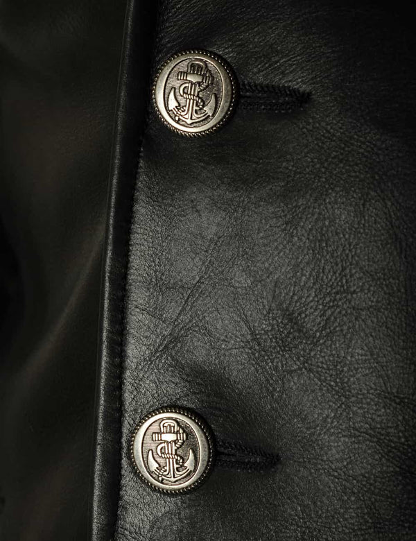 Buttons of a men's black leather pea coat.