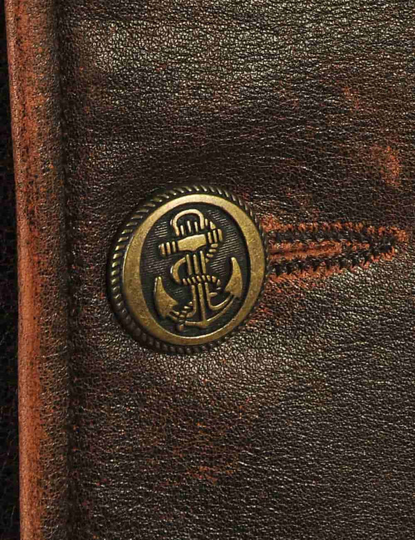 Button on a men's brown leather pea coat.