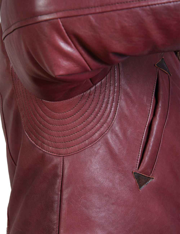 Processing the seam in the armpit part of a burgundy men's leather jacket.