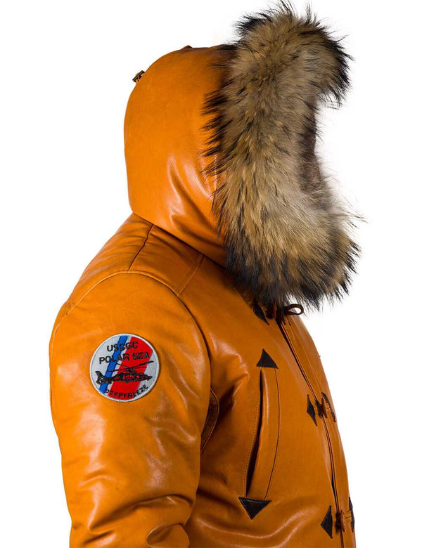 Men's orange leather down jacket on a person, side view, hood on. You can see the round colored patch on the right shoulder.