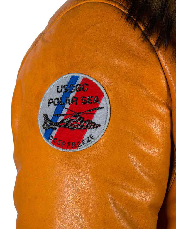 A round colored patch on the right sleeve of a men's orange leather down jacket.
