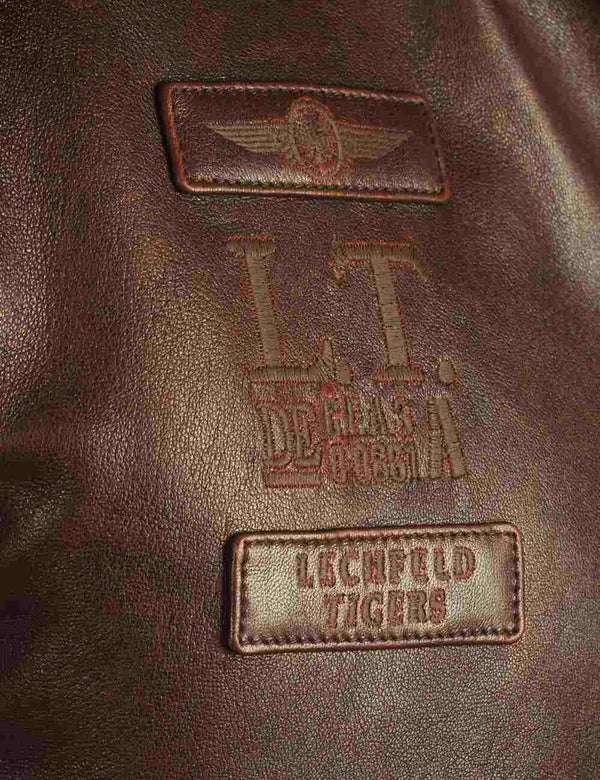 Patches on a brown leather jacket.