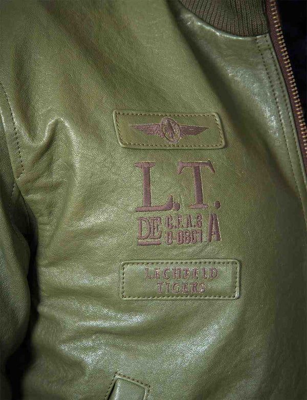 Patch on the chest of a men's olive leather jacket.