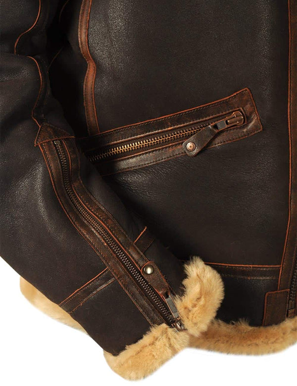 The lower right side of a men's brown sheepskin coat, showing the sleeve with a zipper.