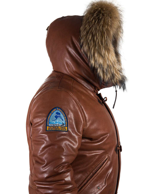 Side view of men's light brown leather parka with raccoon fur trimmed hood.