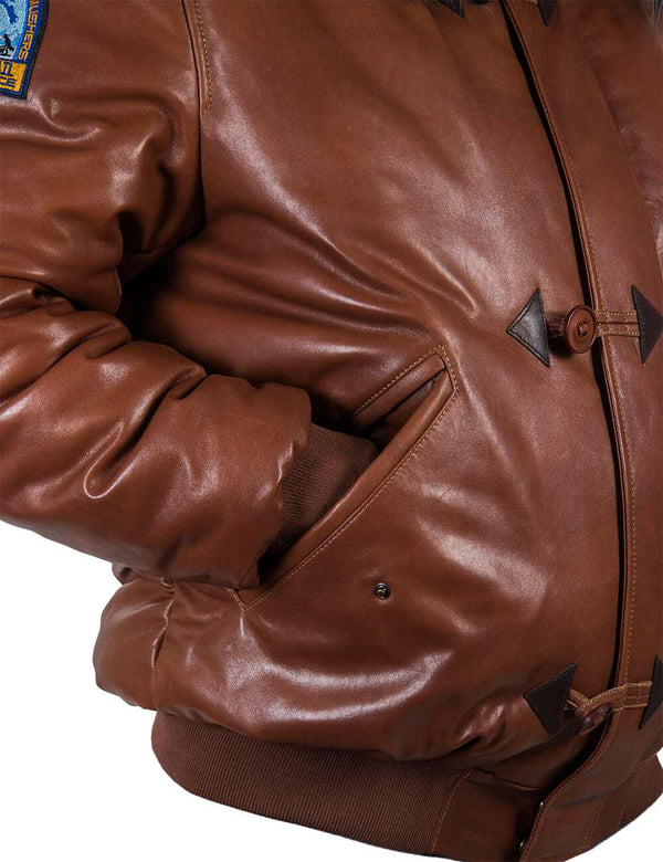 Pocket and sleeve of a men's short parka made of light brown leather.