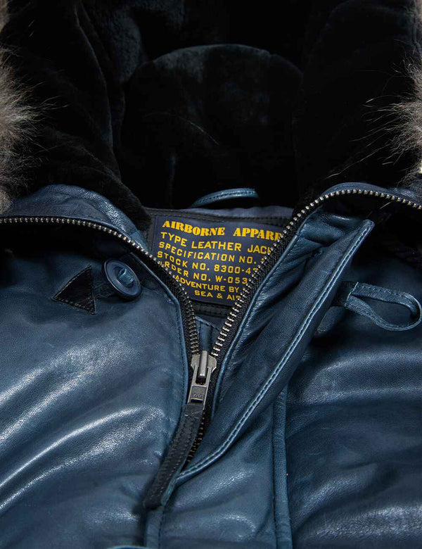 Metal zipper men's blue short leather parka with fur lined hood.
