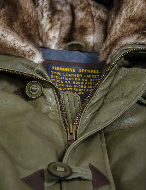 Iron zip and top buttons on the olive leather down jacket with a fur-lined hood.