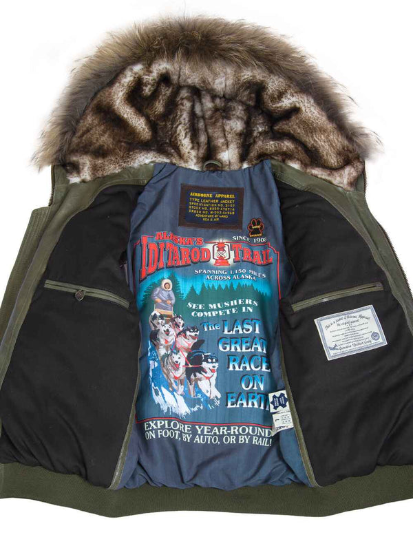 Men's olive leather down jacket with elastic band and sheepskin-lined hood, unbuttoned. You can see the inner lining with a bright print.