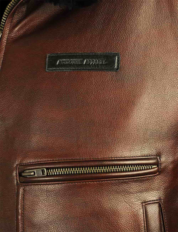 Name tag on the chest of a men's brown leather jacket.