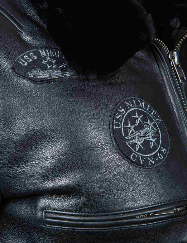 Patches on the chest of a men's black leather jacket with a fur collar.