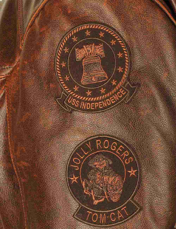Round patches on the left sleeve of a men's brown leather jacket.