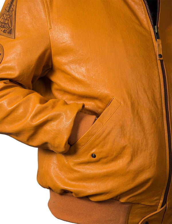 The right side of a men's orange leather jacket, the sleeve is in the pocket.