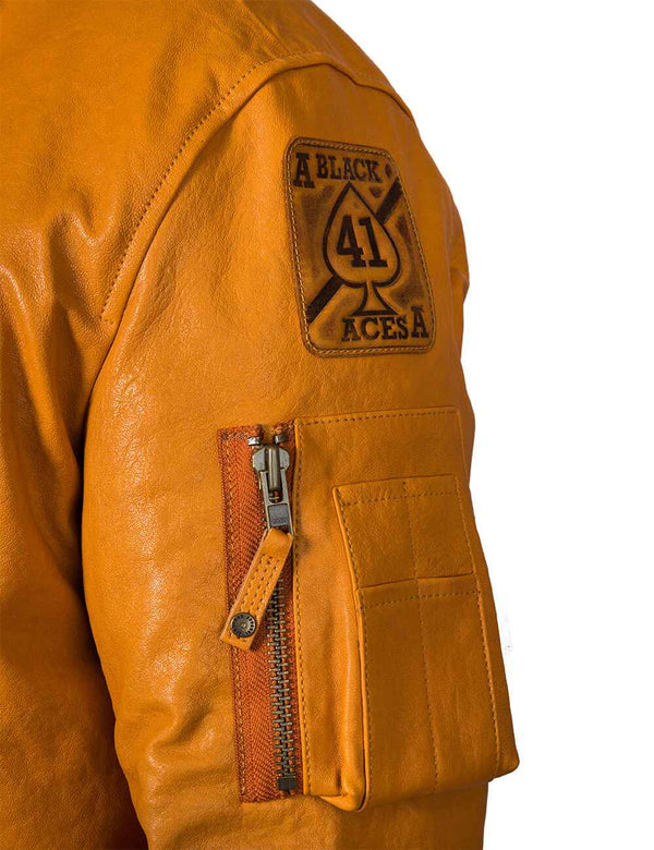 Utility pocket and patch on the sleeve of a men's orange leather jacket.