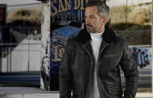 A man in a black leather jacket.