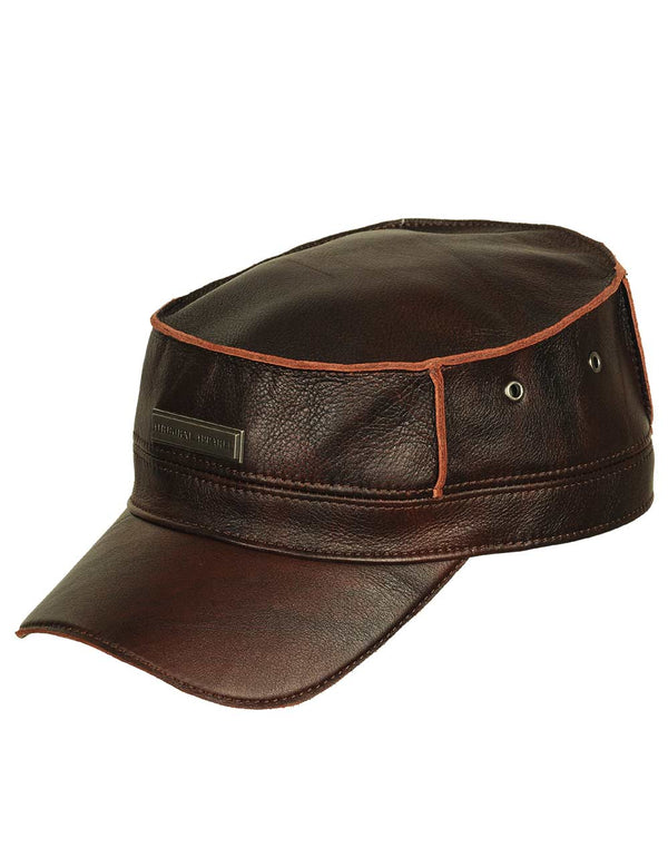 Men's brown leather flat top cap with metal badge, slight twist.