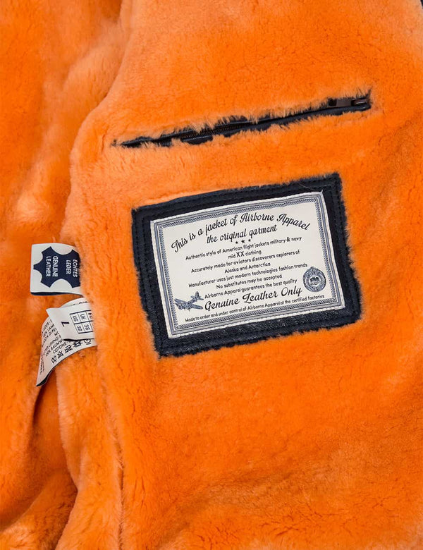 An inside pocket and a patch on the orange fur lining of the men's jacket.