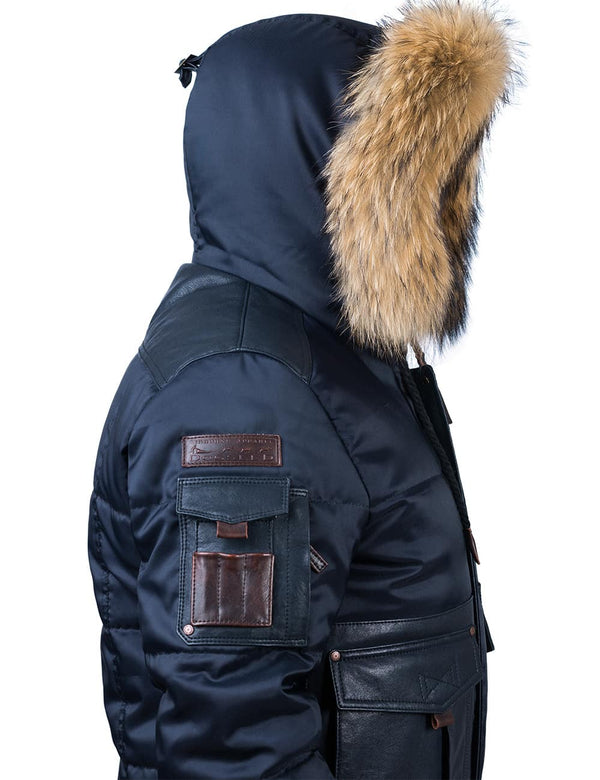 Men's dark blue jacket with raccoon fur trimmed hood, side view.