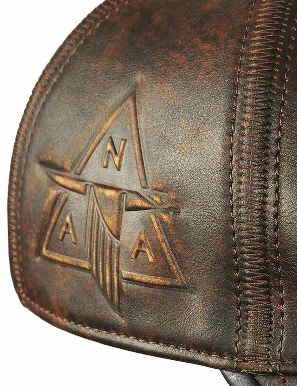 Leather embossed letters on a brown leather cap