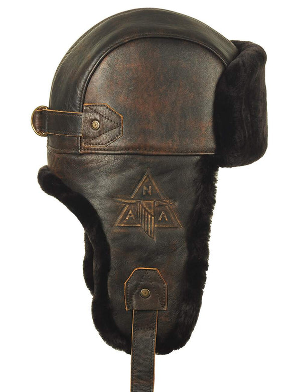 Men's brown trapper hat with leather top and sheepskin lining side view