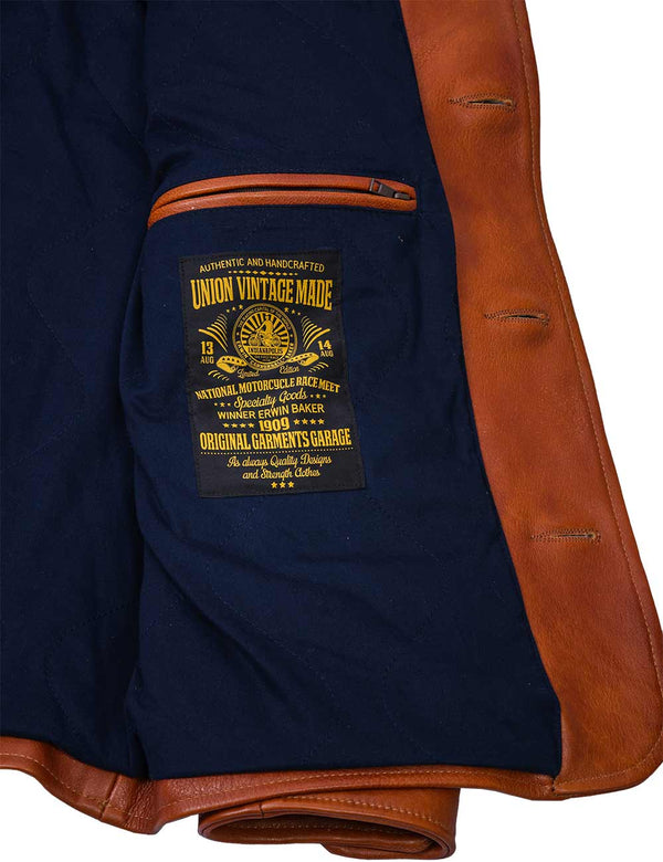 Inside pocket and patch on dark blue lining of light brown men's leather jacket.