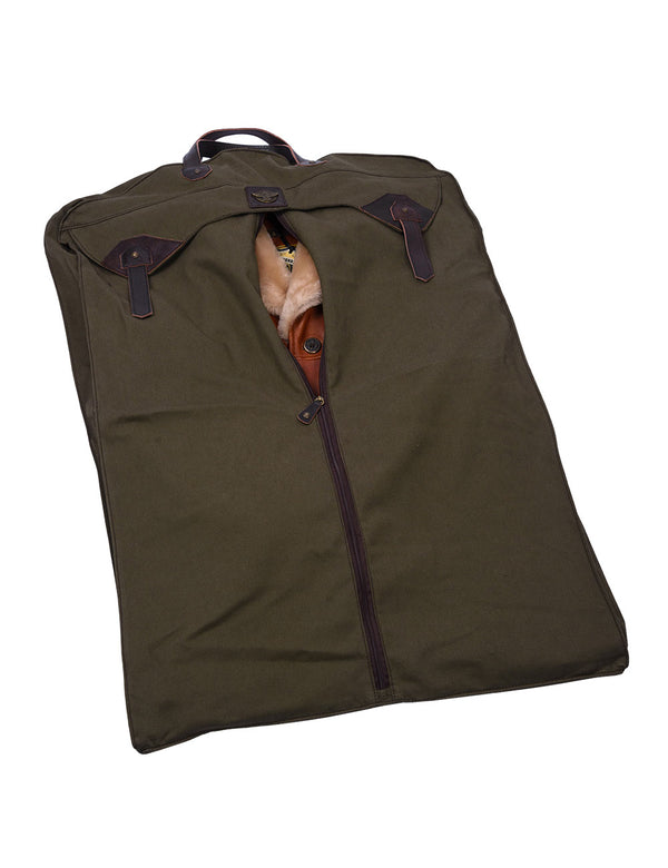 An orange leather jacket inside an olive green fabric bag.