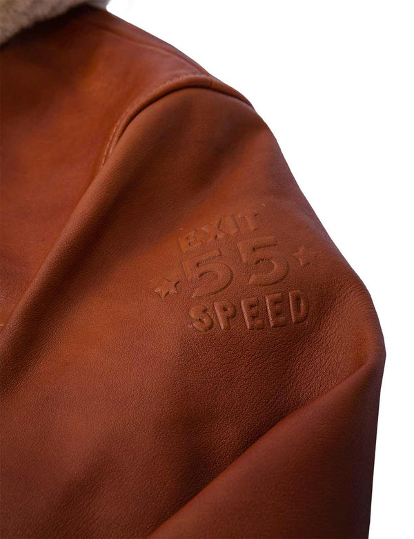 Embossing on the left sleeve of a men's light brown leather jacket.