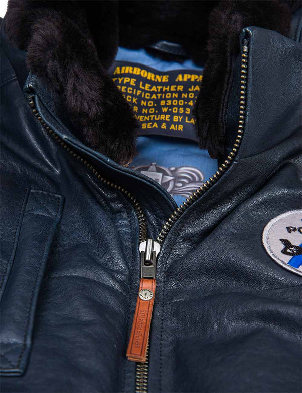 Fur collar and metal zipper on a dark blue leather vest.