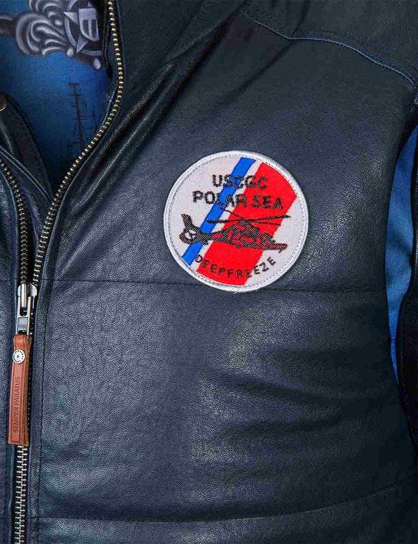 A bright round patch on the chest of a dark blue leather men's vest.