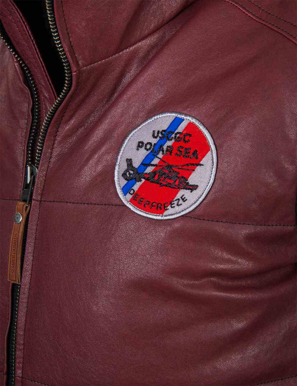 Round patch on the chest of a men's burgundy leather vest.