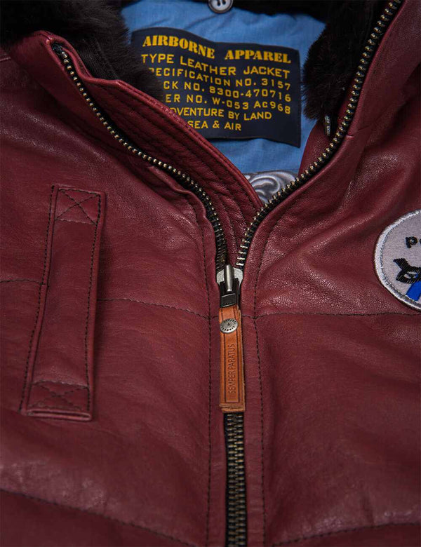 A metal zipper on the men's burgundy leather vest.