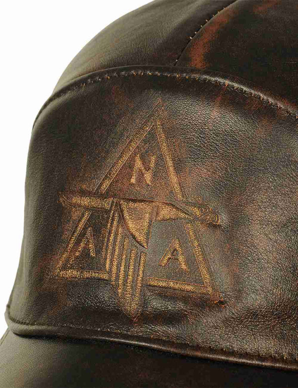 Embossed letters on leather cap