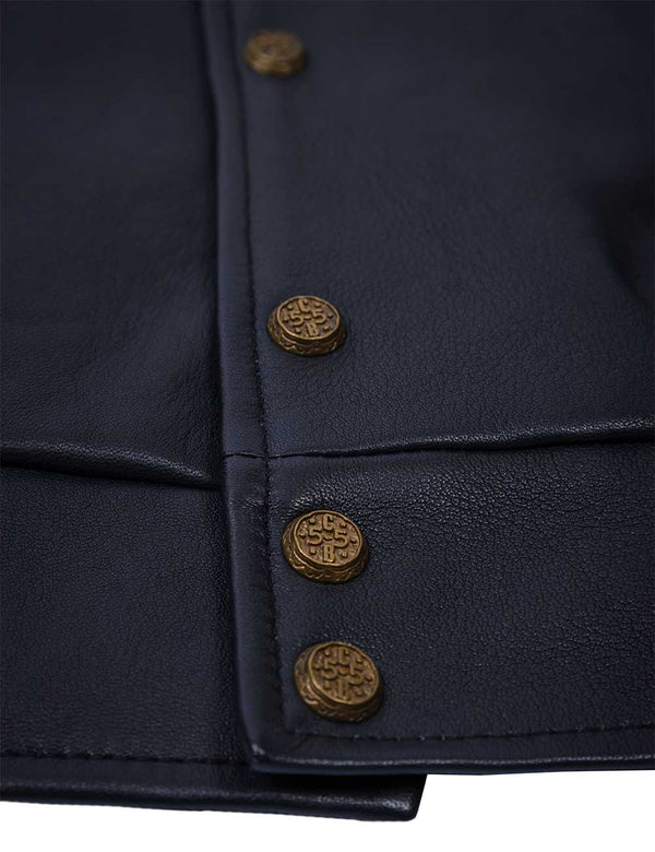 Golden lower metal buttons of men's dark blue leather jacket.