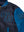 The upper left side of a dark blue leather men's jacket with a light blue sleeve and collar. There are also patches on the chest and shoulder.