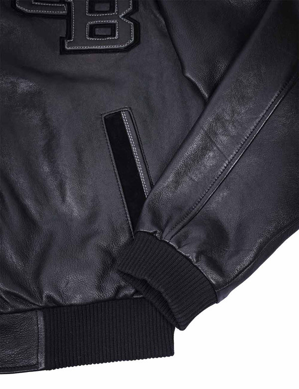 Left pocket and sleeve of a men's black leather jacket with elastic band.