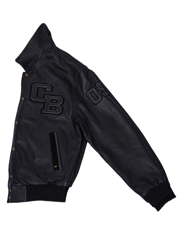 Left side of a black leather short jacket with the letters C and B on the chest on a white background.