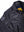 The top right side of a men's black leather jacket shows the text patch on the right shoulder and the jacket's name on the chest.