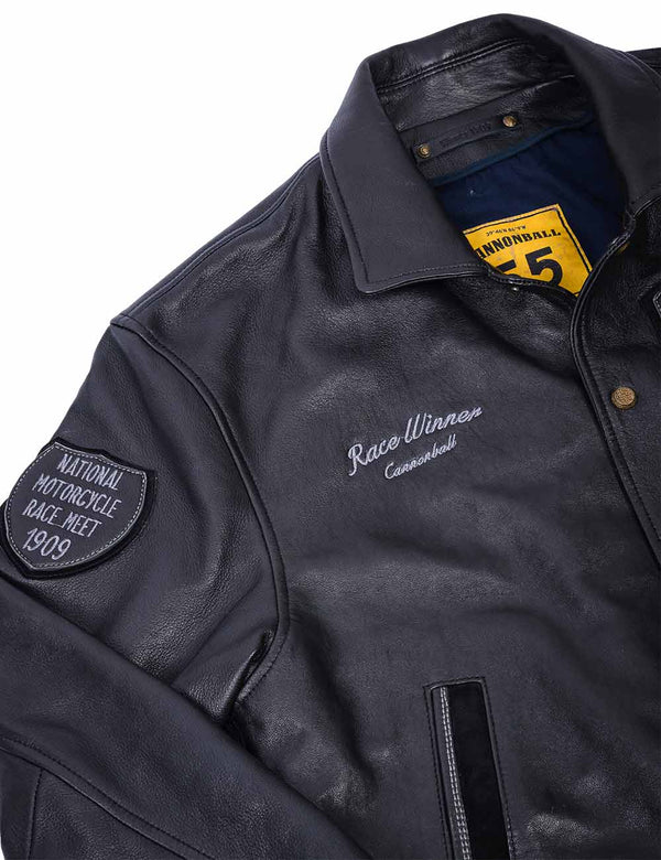 The top right side of a men's black leather jacket shows the text patch on the right shoulder and the jacket's name on the chest.