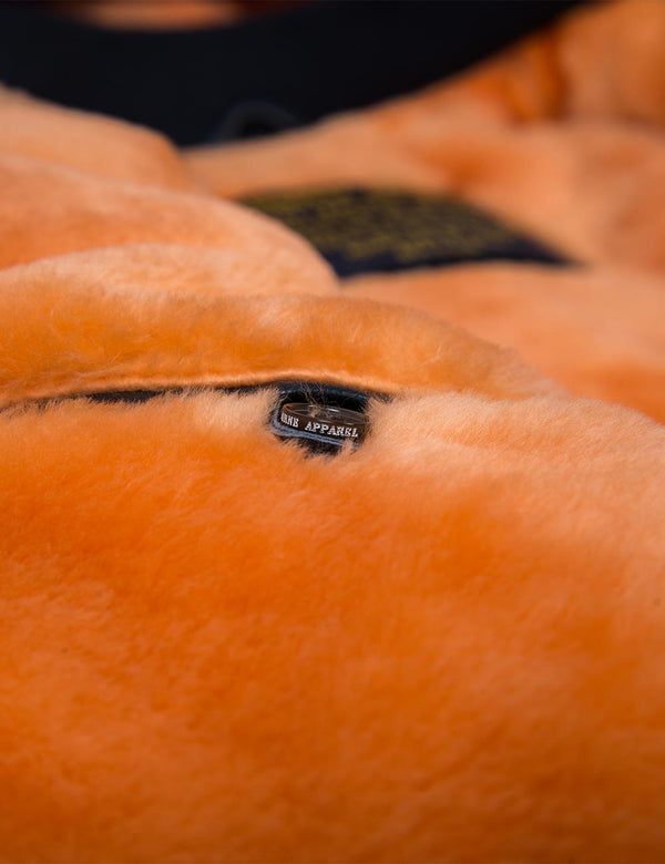 Orange fur lining on men's dark blue jacket.