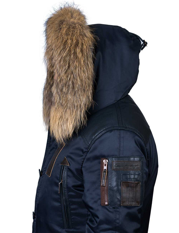 Men's dark blue parka with raccoon fur trimmed hood, side view.