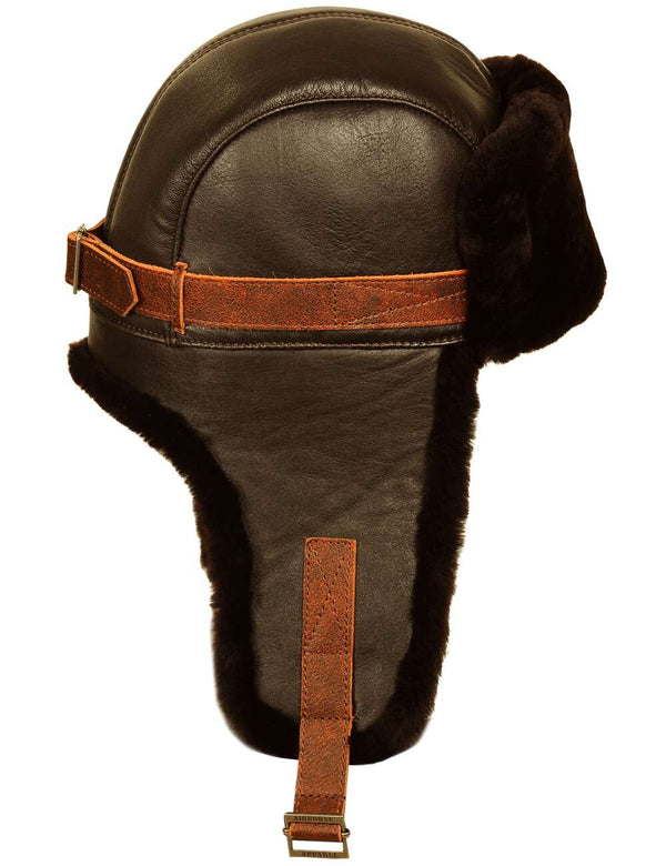 Men's brown leather trapper hat with sheepskin lining, side view.