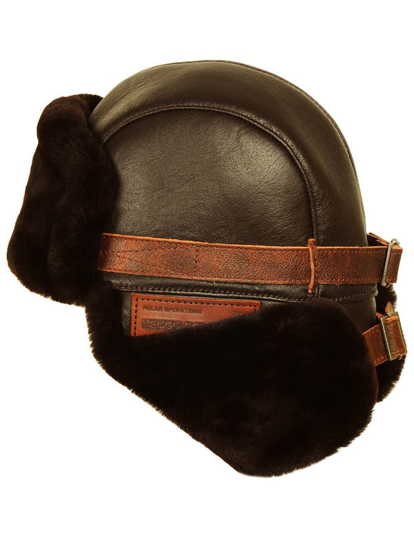 Men's brown leather trapper hat with sheepskin lining and buttoned earflaps, back view.