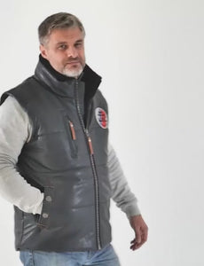 In the video, the man shows off a dark blue leather insulated vest with a fur stand-up collar and a patch on the chest.