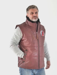 In the video, the man shows off a burgundy leather vest with a fur collar and a round patch on the chest.