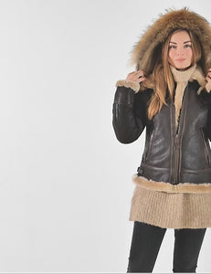 In the video, the woman shows off a short brown sheepskin jacket with a hood.