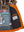 Left side of men's orange hooded leather jacket showing bright lining and inside pocket.