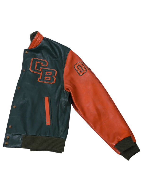 The left side of a men's dark green leather jacket with orange sleeves, collar, and trim. There are also patches on the sleeve and chest.