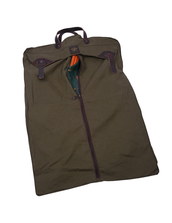 An olive fabric bag, from the inside of which a small part of a green leather jacket with an orange collar is visible.