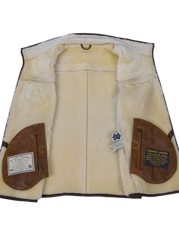 Men's light brown sheepskin vest with light fur, unbuttoned, showing the fur and inner pockets.