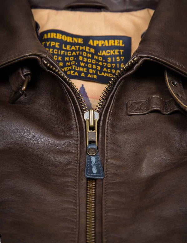 Metal zipper on a women's brown leather jacket.